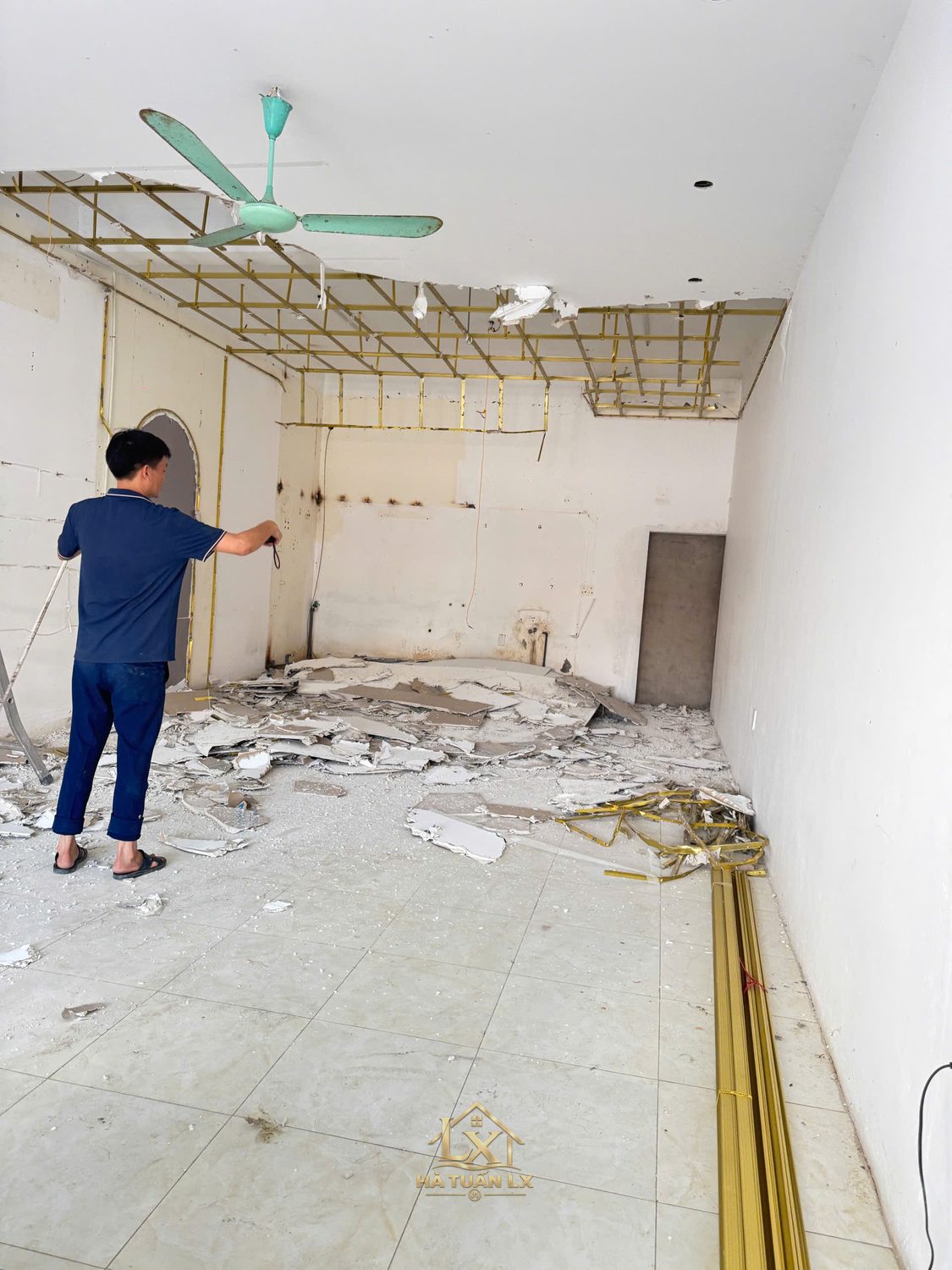 Hiện trạng mặt bằng cũ trước khi cải tạo — trần cũ được dỡ bỏ, tường loang mốc, sàn gạch cũ.